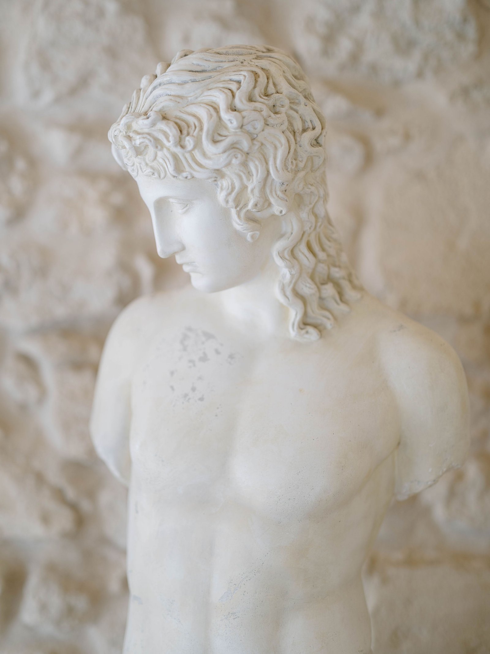French wedding photographer detail of classical marble statue at Chateau Gassies in soft natural light
