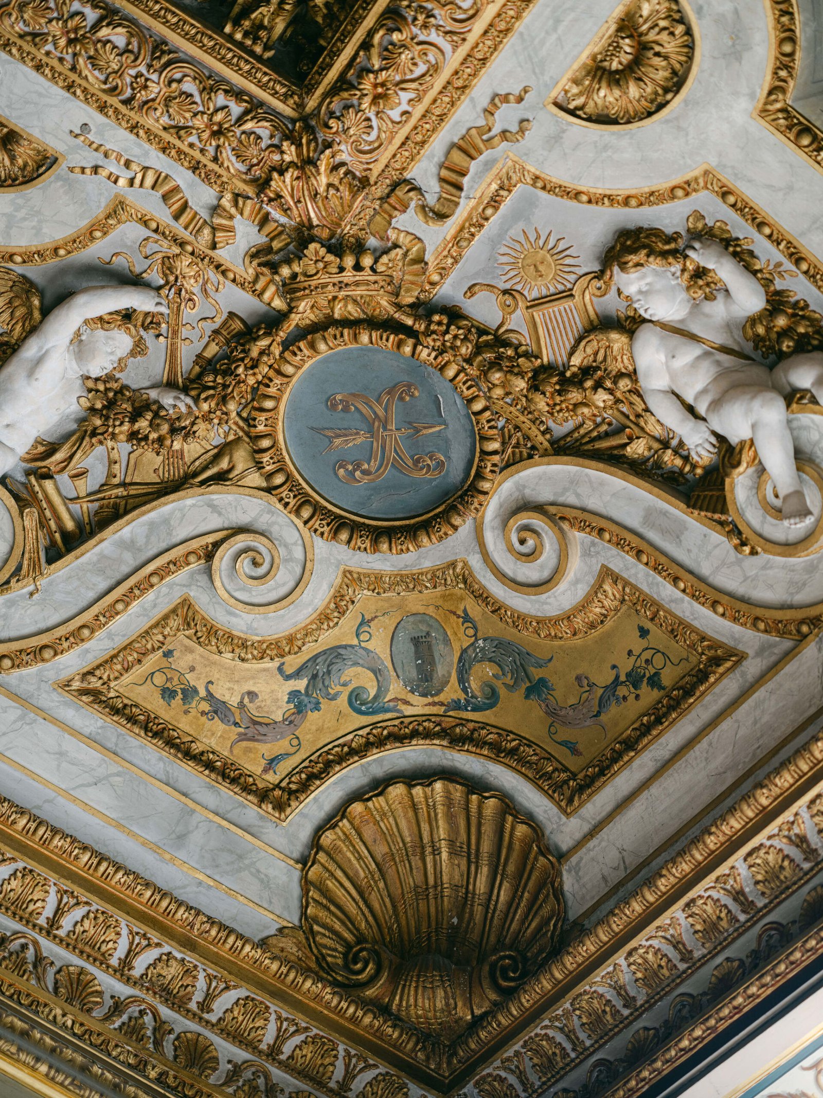 Grand salon interior at Château de Vaux-le-Vicomte showing gilded ceiling, baroque architectural detail and painted panels