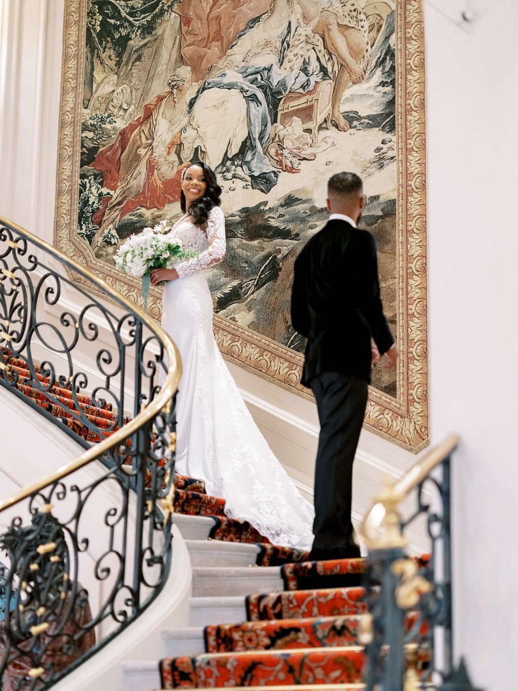 Bride in white lace gown on grand Ritz Paris staircase during first look