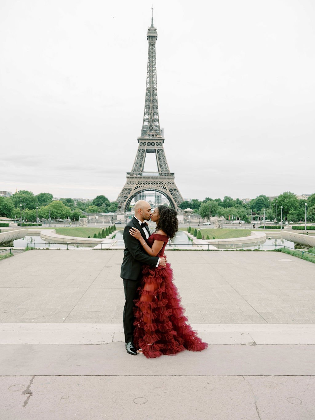 trocadero eiffel tower anniversary couple burgundy gown embrace golden hour