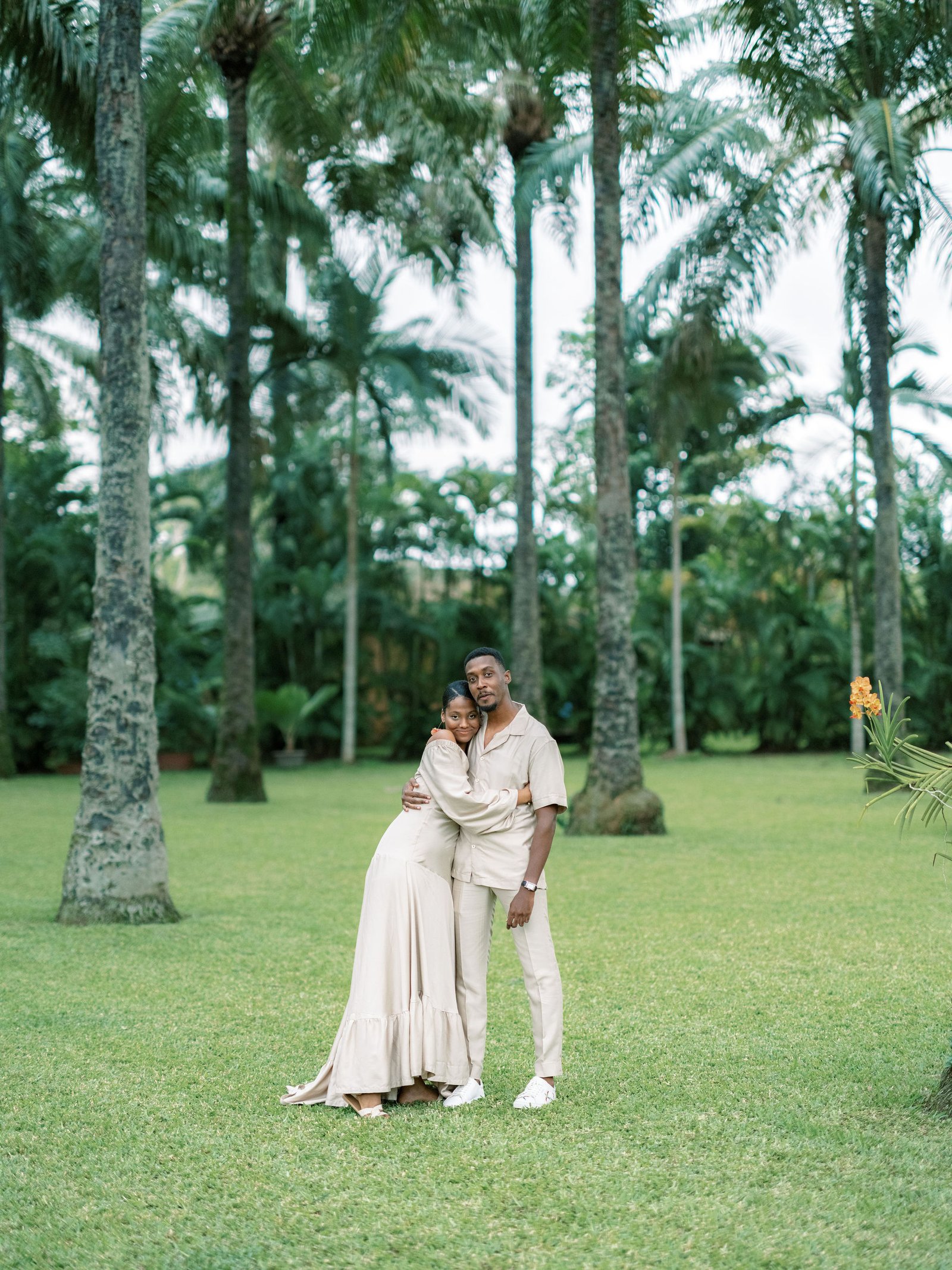 Couple embracing intimately in a palm grove in Abidjan in soft evening light