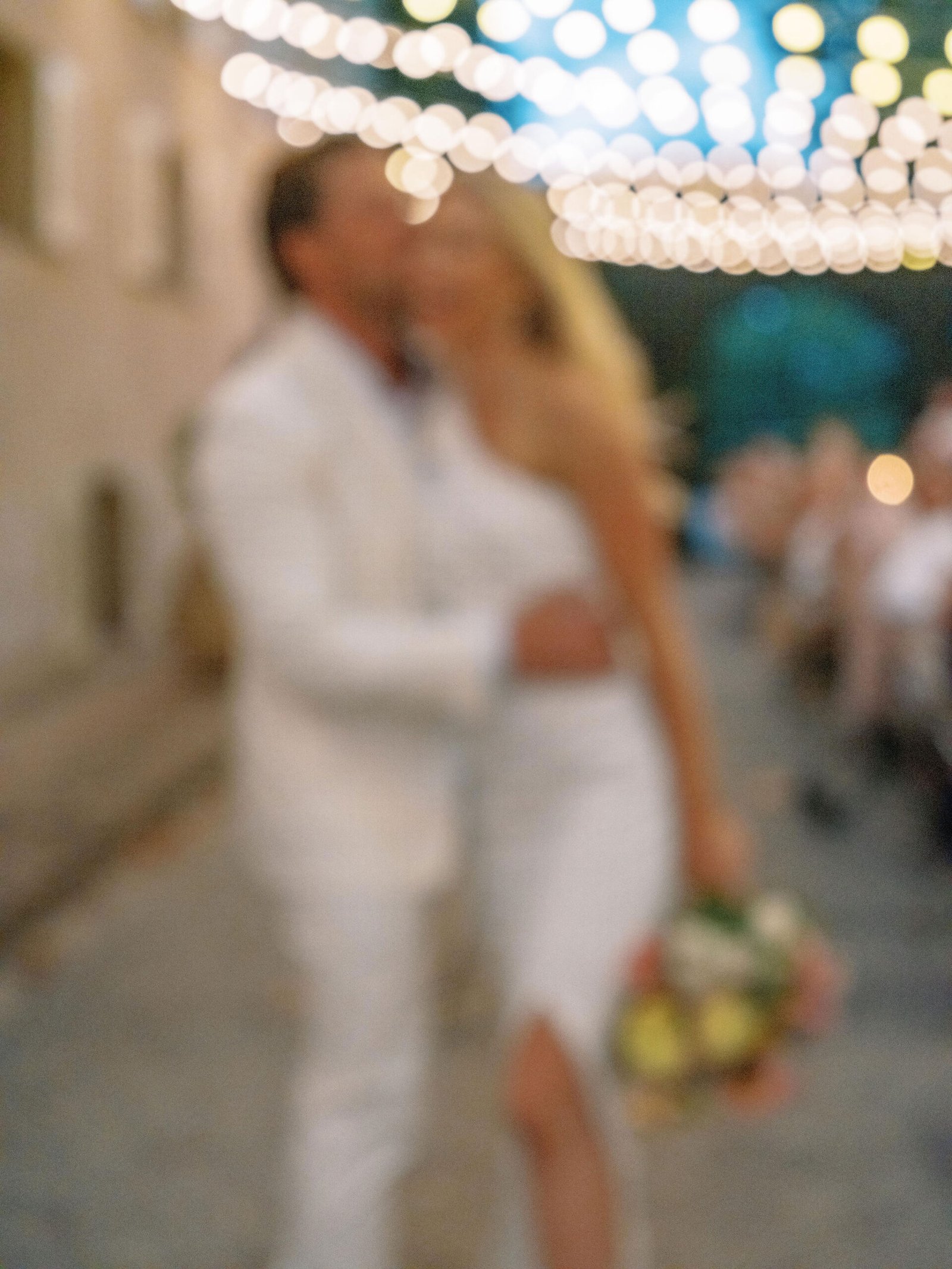 First dance at Chateau Sainte Roseline with fairy lights creating a romantic blur above the couple in Provence