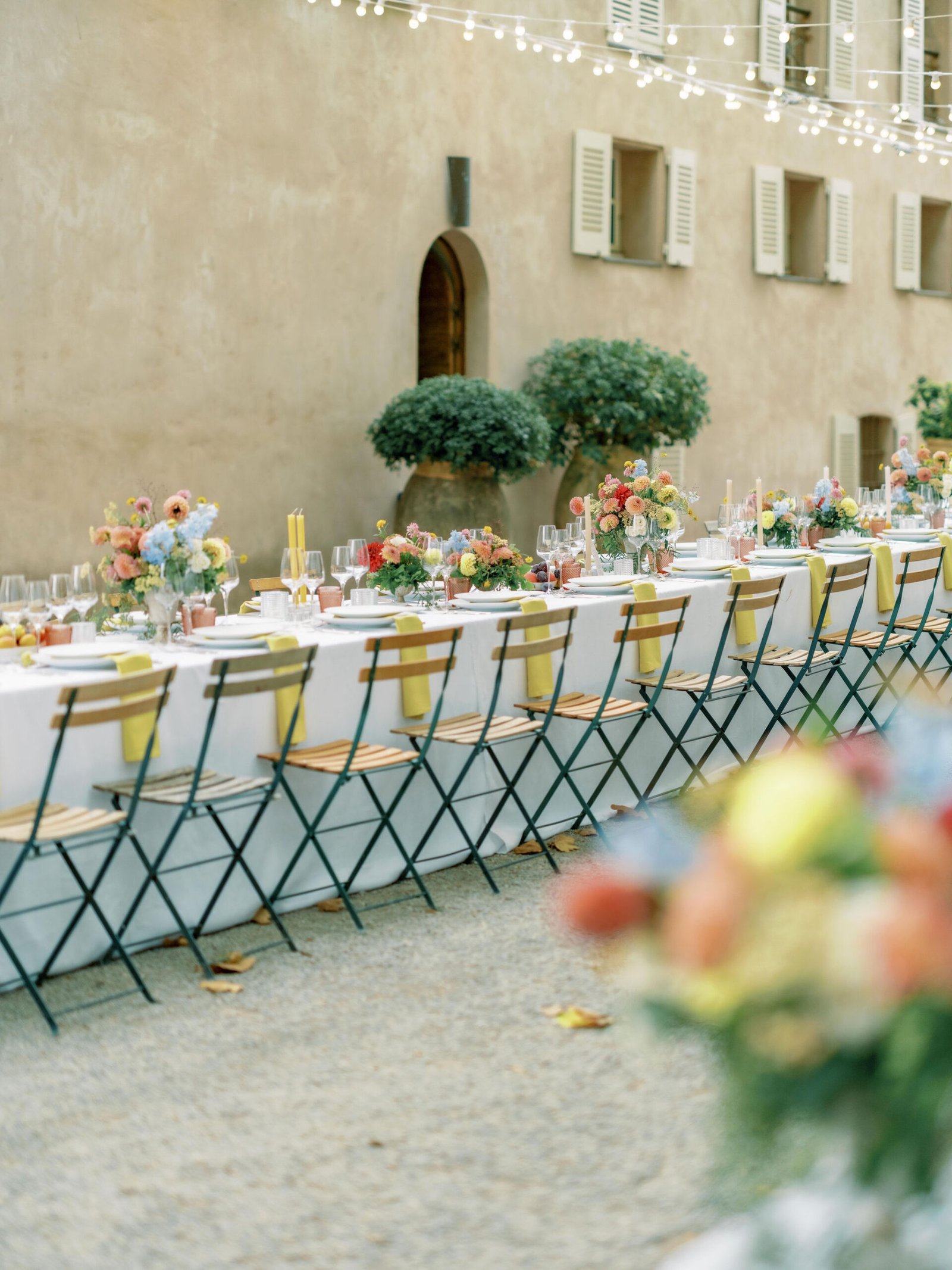 Chateau Sainte Roseline reception long table with fairy lights in Provence courtyard