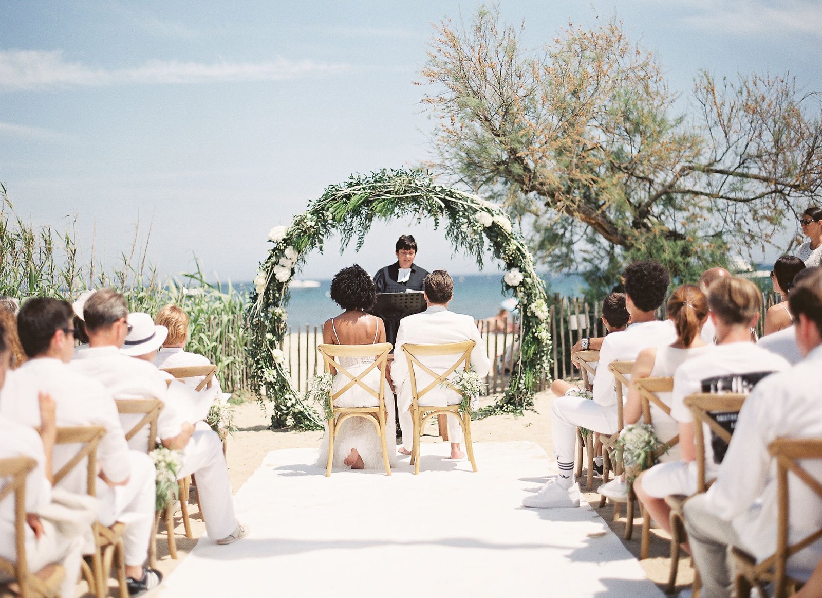 Intimate beach ceremony at Pan Deï Palais Saint-Tropez with circular floral arch and Mediterranean sea backdrop
