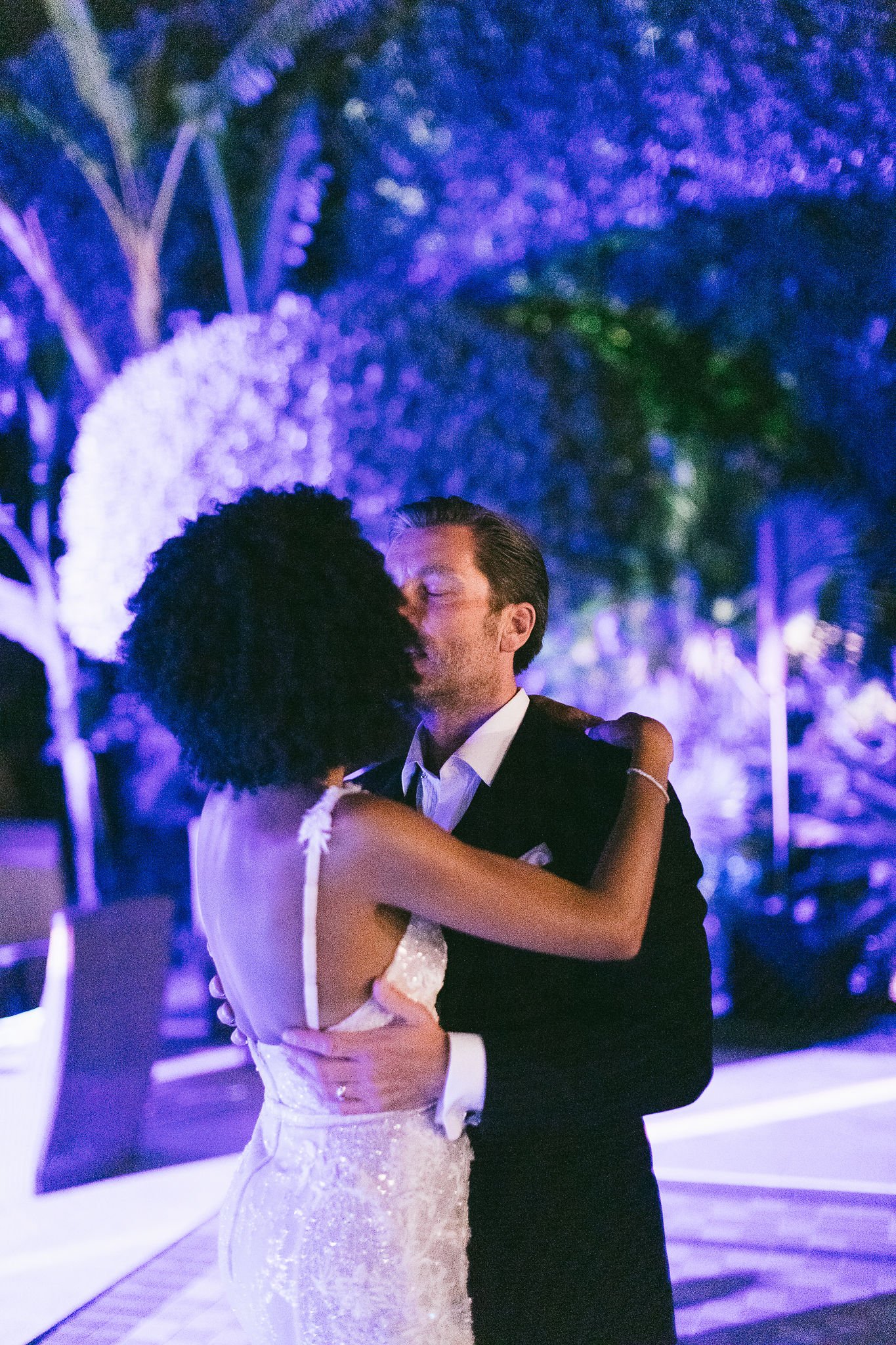 Couple sharing their first dance under dramatic purple uplighting at Pan Deï Palais in Saint-Tropez