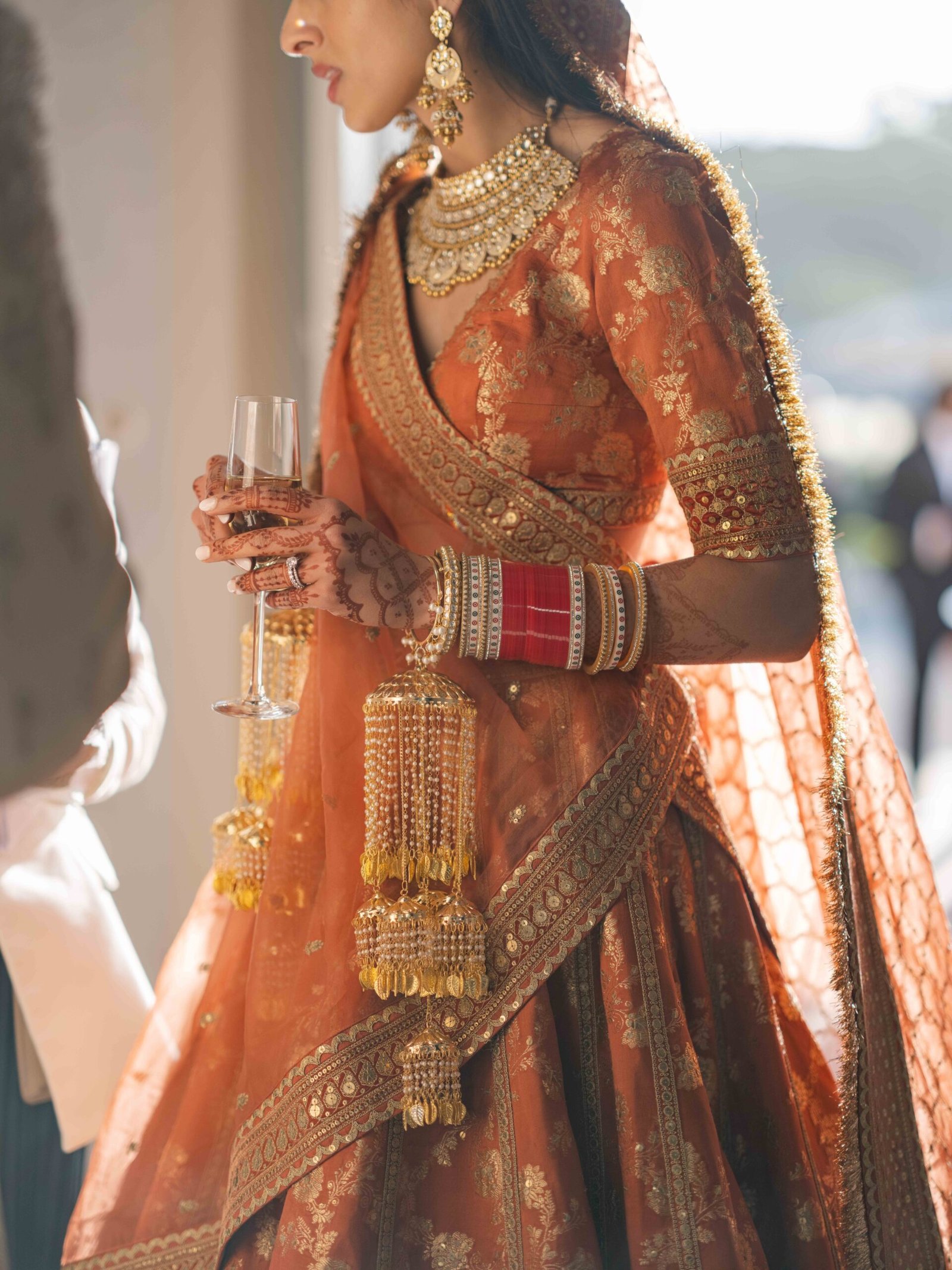 Indian bride in a lehenga with kaleere and henna during the cocktail hour in Lisbon, golden hour