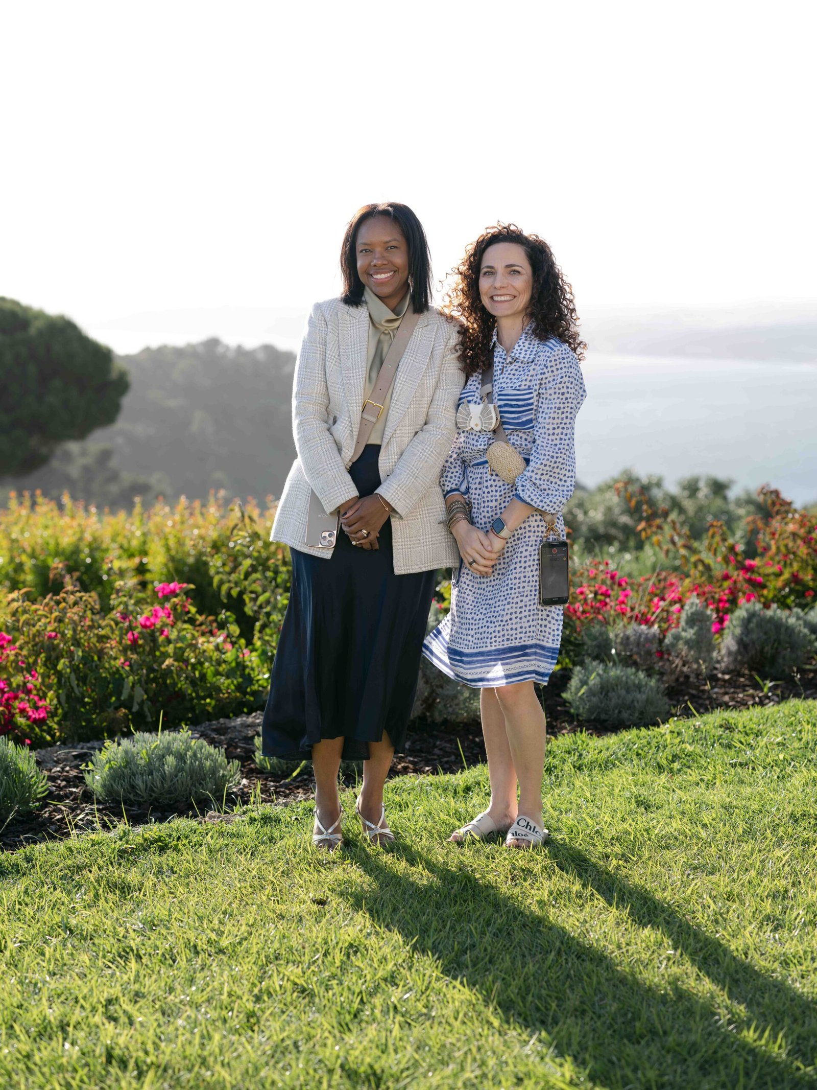 Wedding guests posing in a coastal garden during the cocktail hour in Lisbon, golden hour