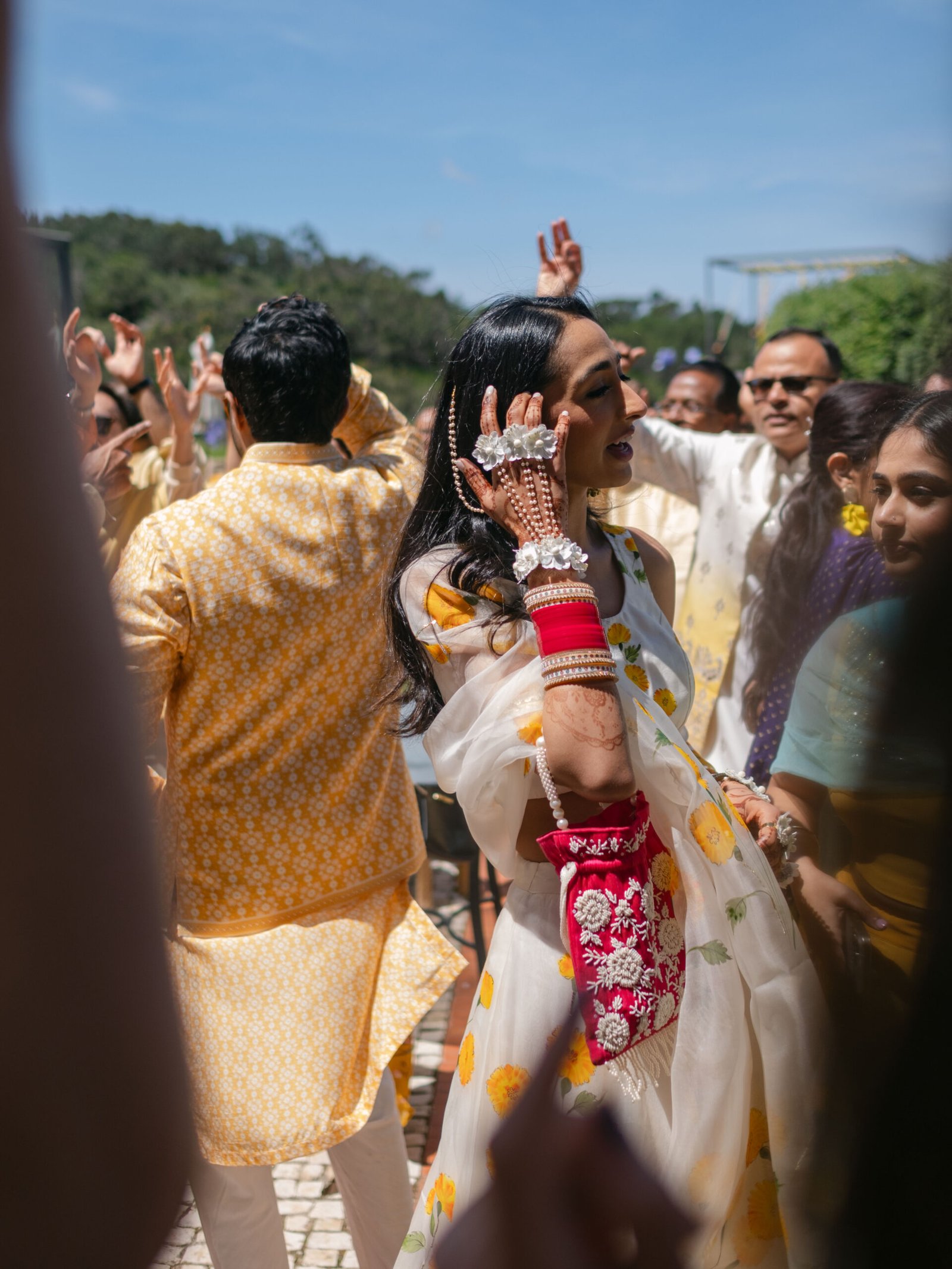 Indian bride in red and gold during the baraat celebration at her Lisbon wedding