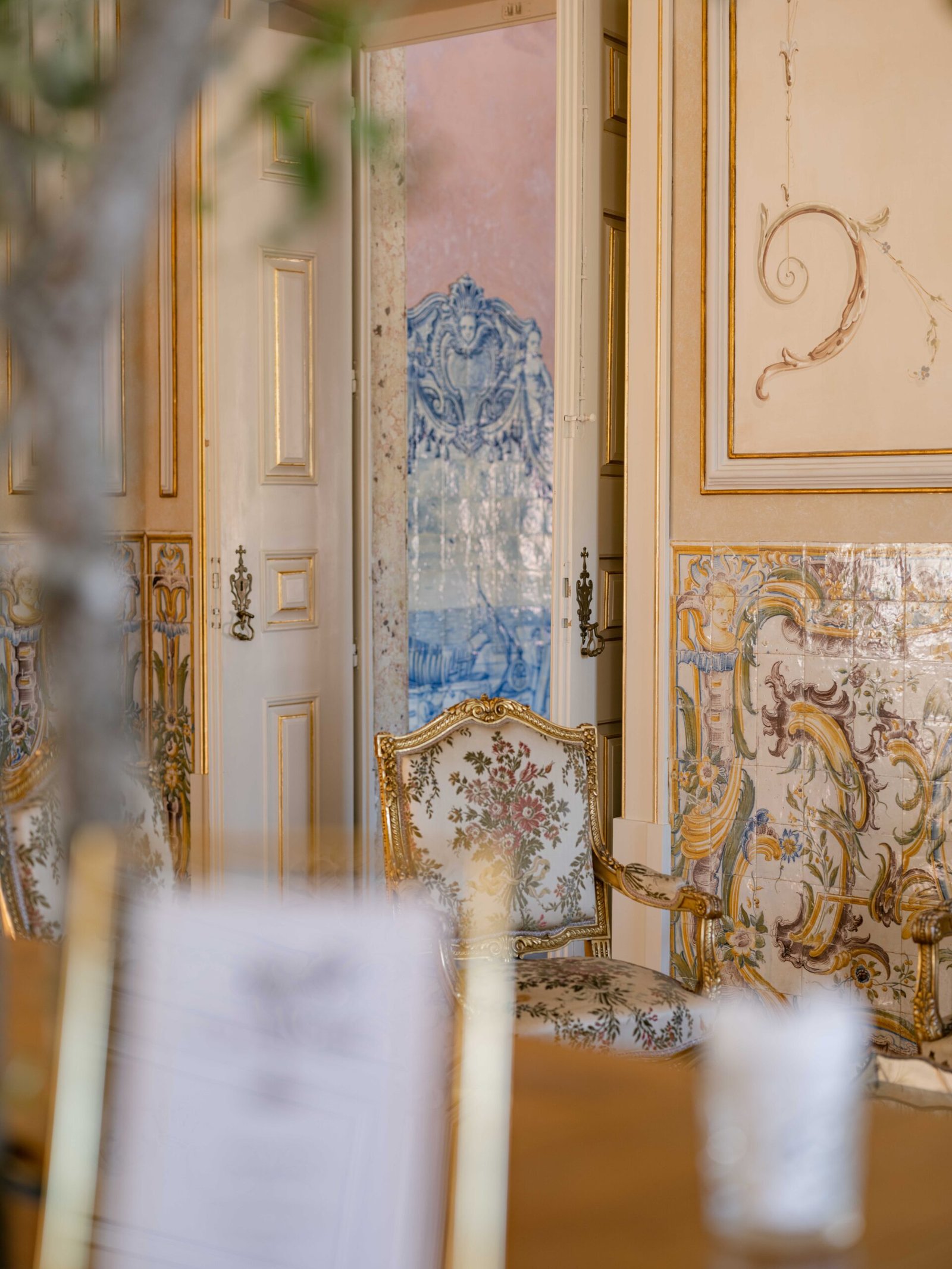 Gilded chair against blue azulejo tiles at a palace wedding reception in Lisbon