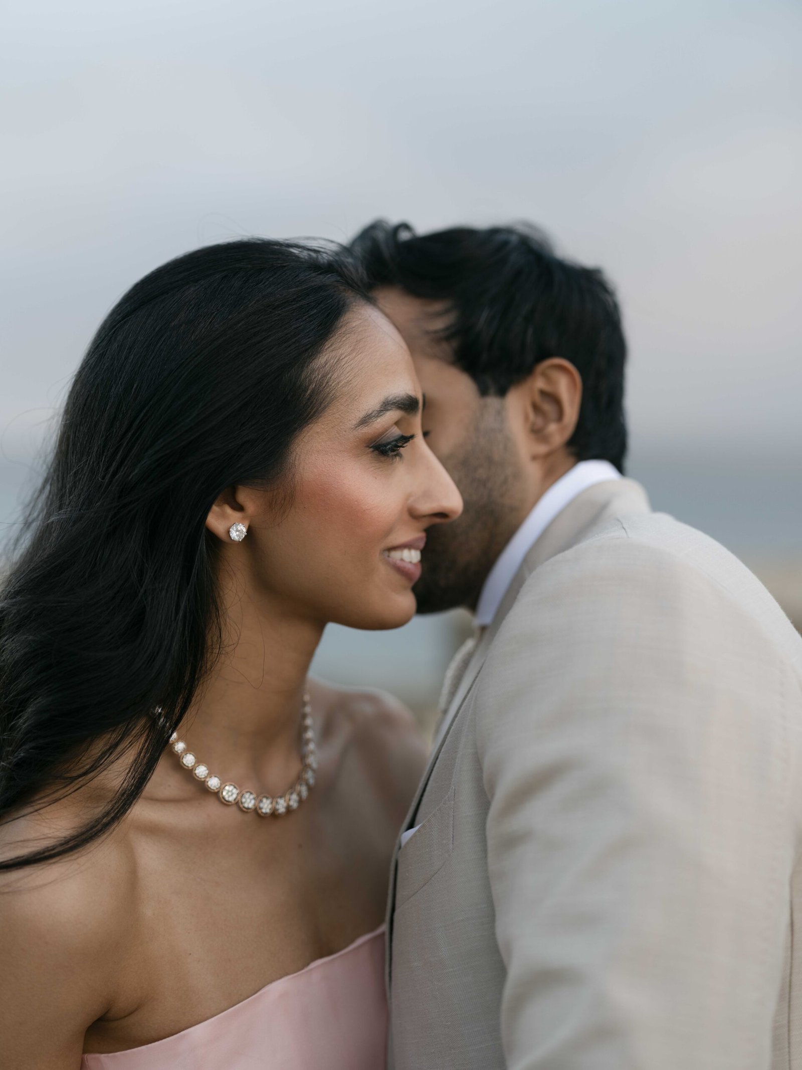 Couple in a blush gown and diamond jewelry at blue hour, wedding portrait in Lisbon