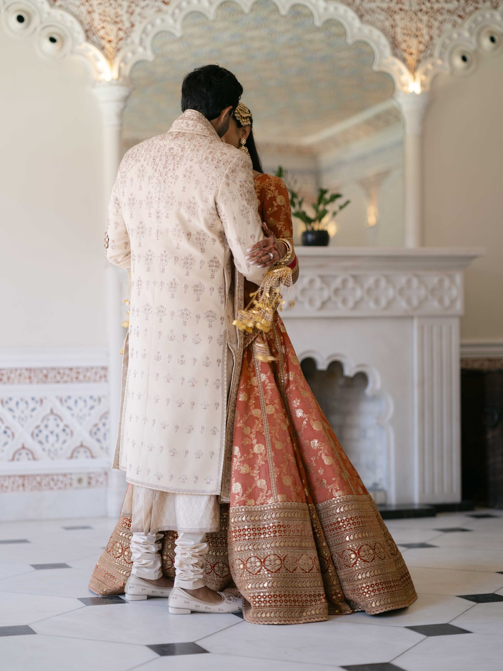 Indian couple under a Moorish archway, the bride in an embroidered lehenga, Lisbon