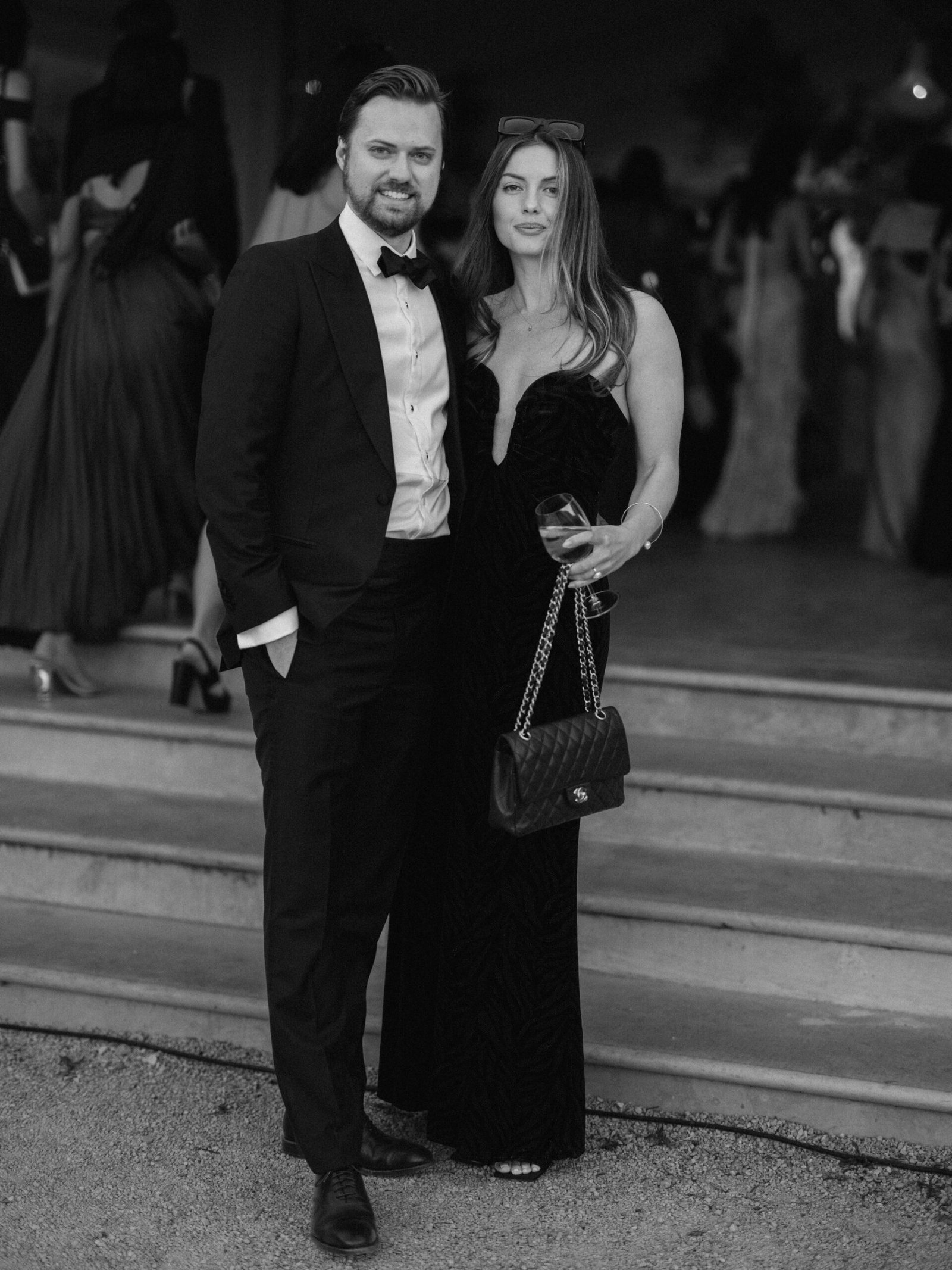 Black and white portrait of a guest couple in black tie at a wedding cocktail in Lisbon