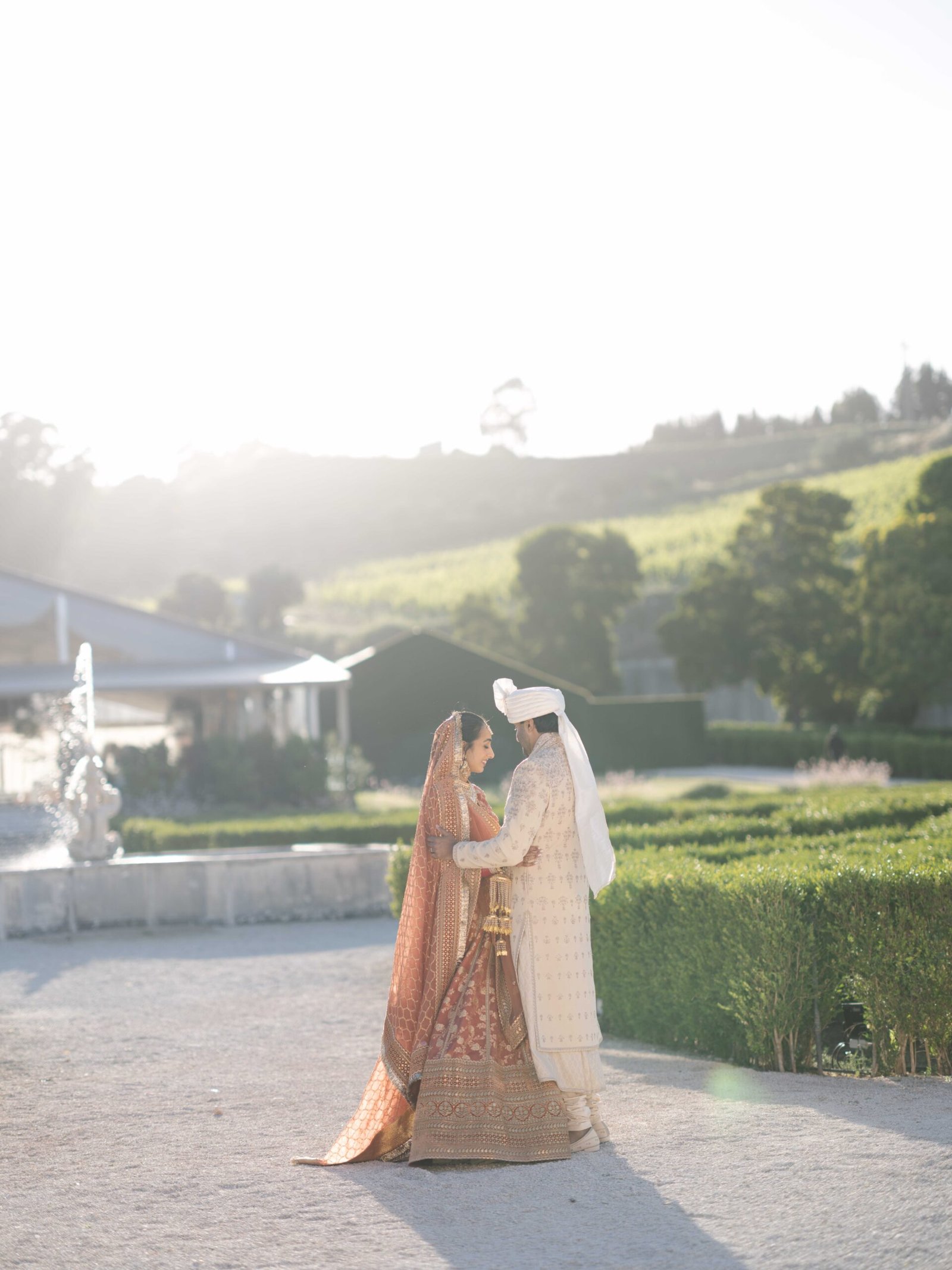 Indian couple in wedding attire in a hillside garden near Lisbon at golden hour