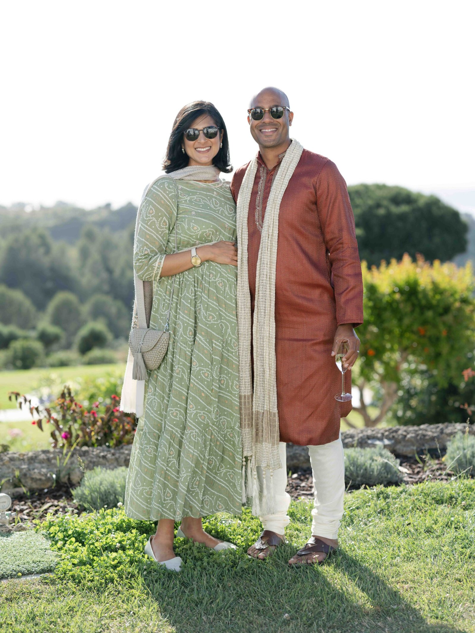 Couple in traditional Indian attire in a garden near Lisbon at golden hour