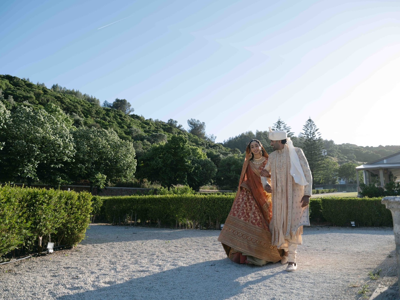 Indian couple in traditional attire in a garden in Lisbon at golden hour