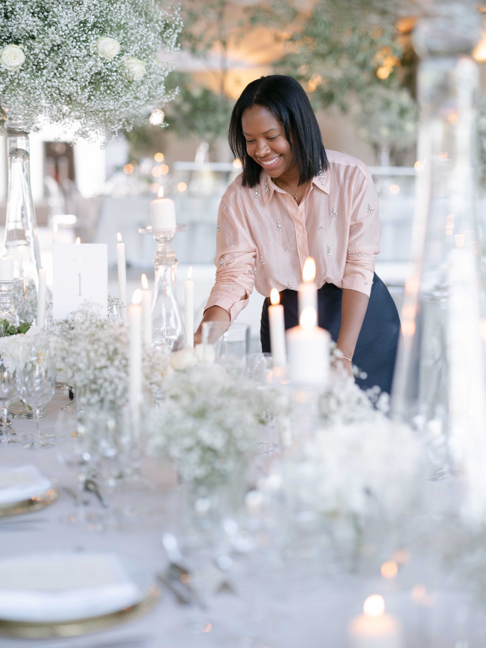 The Wedding Wonderland planner arranging a baby's breath and candlelight tablescape in Lisbon