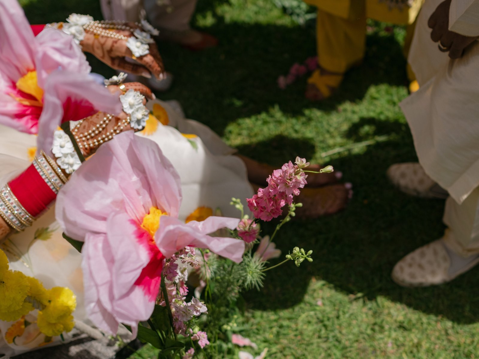 Bridal bangles resting on pink peonies in a Lisbon garden