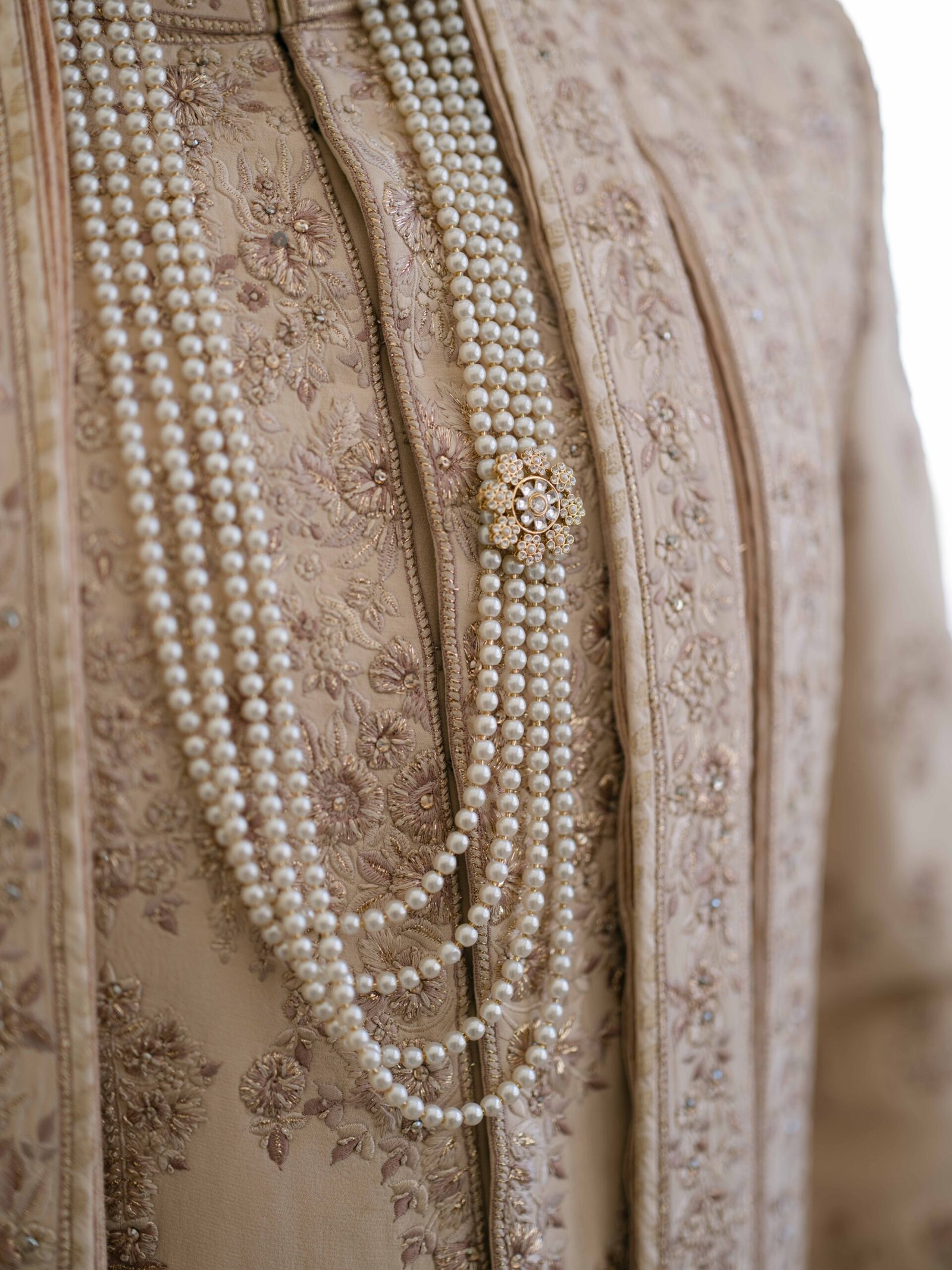 Groom's sherwani with pearl strands and a brooch, Indian wedding in Lisbon
