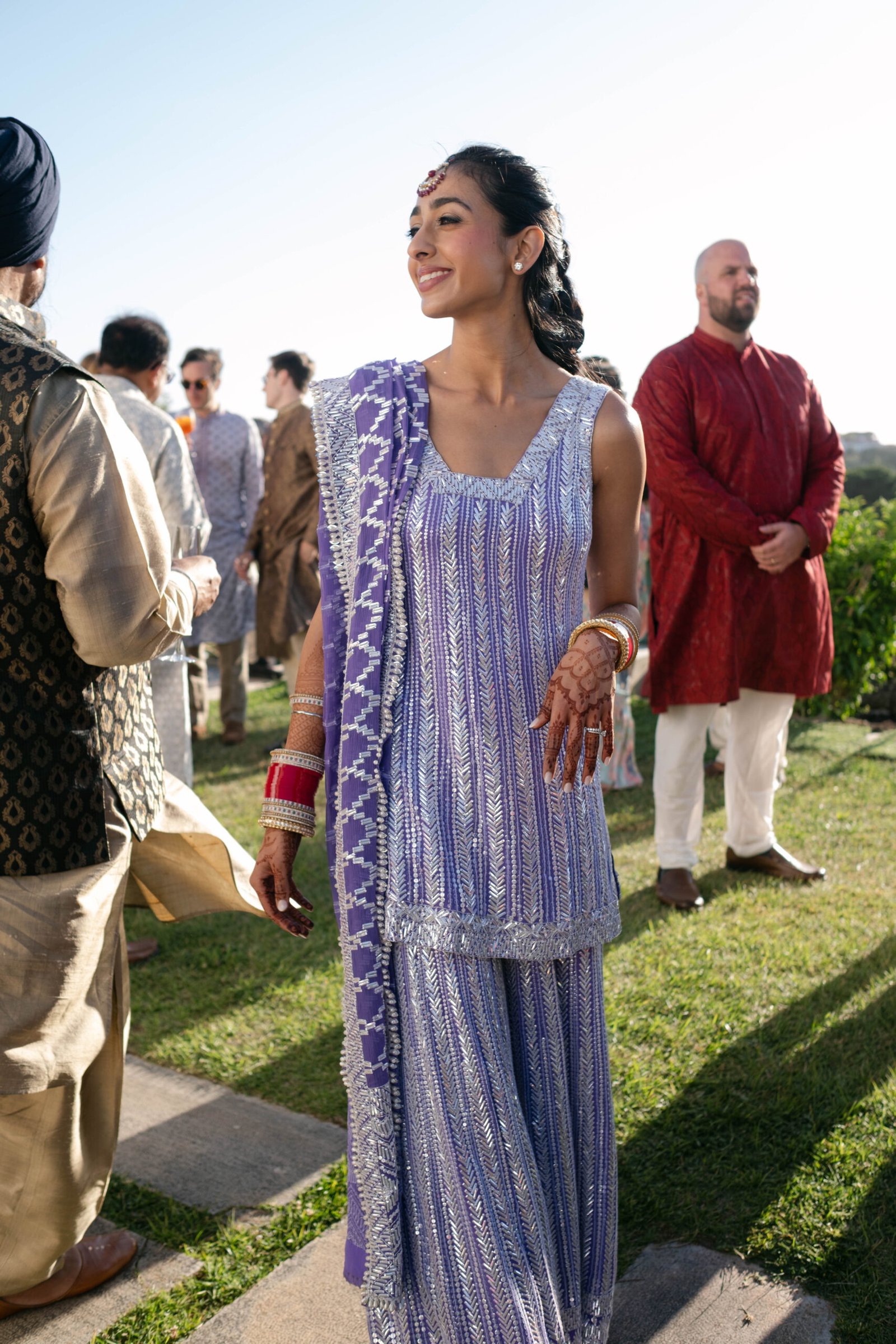 Guest in a blue lehenga on the lawn before the wedding ceremony in Lisbon, golden hour