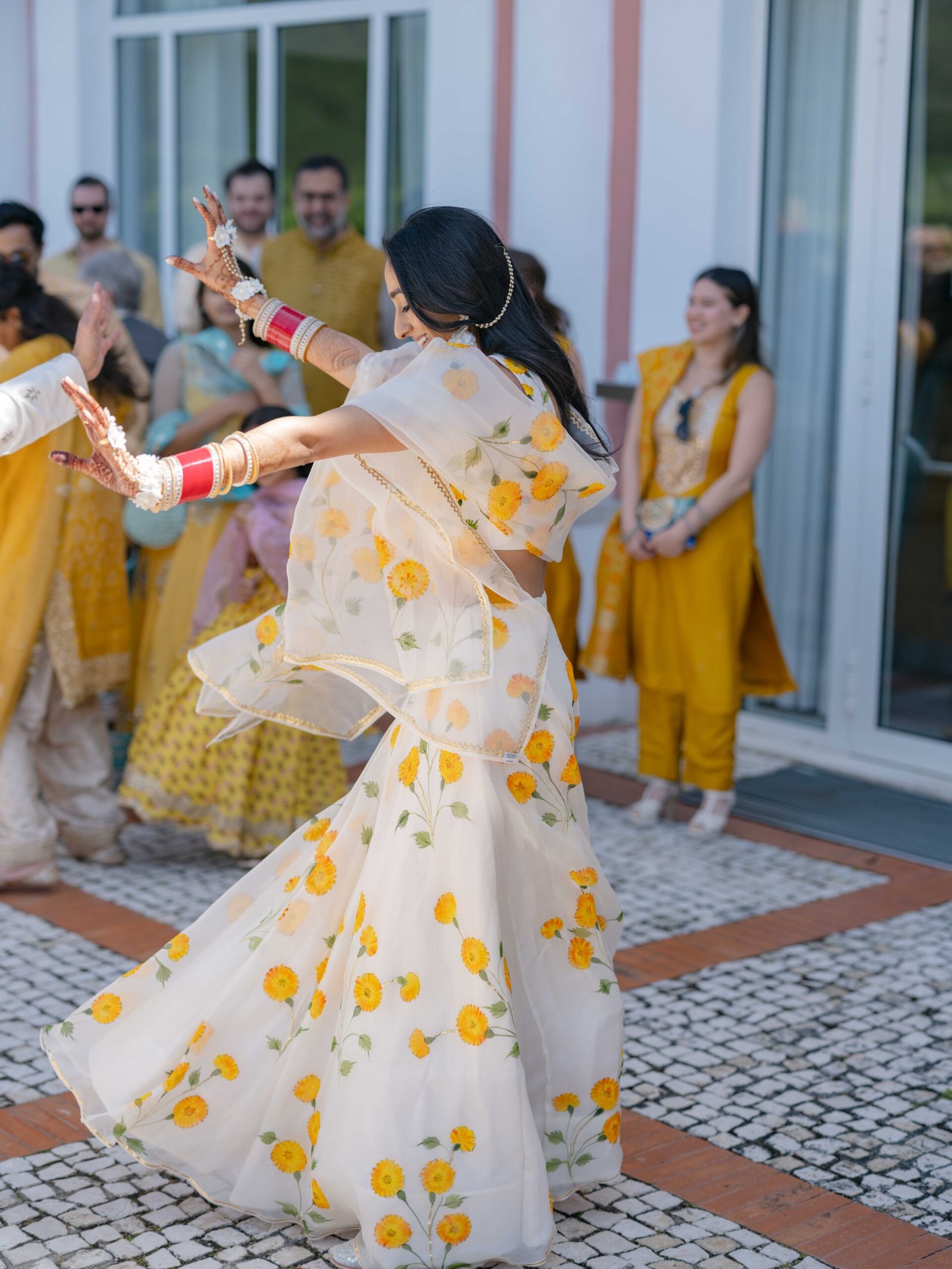 Bride twirling in a floral lehenga during the wedding celebrations in Lisbon