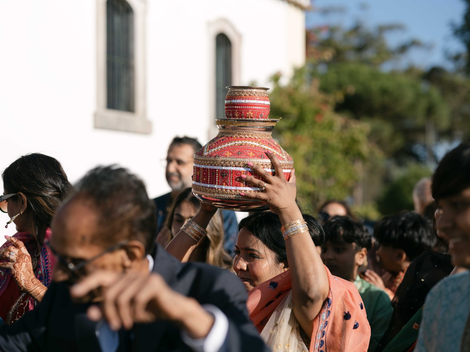 Procession with a decorated kalash during an Indian wedding ceremony in Lisbon, golden hour