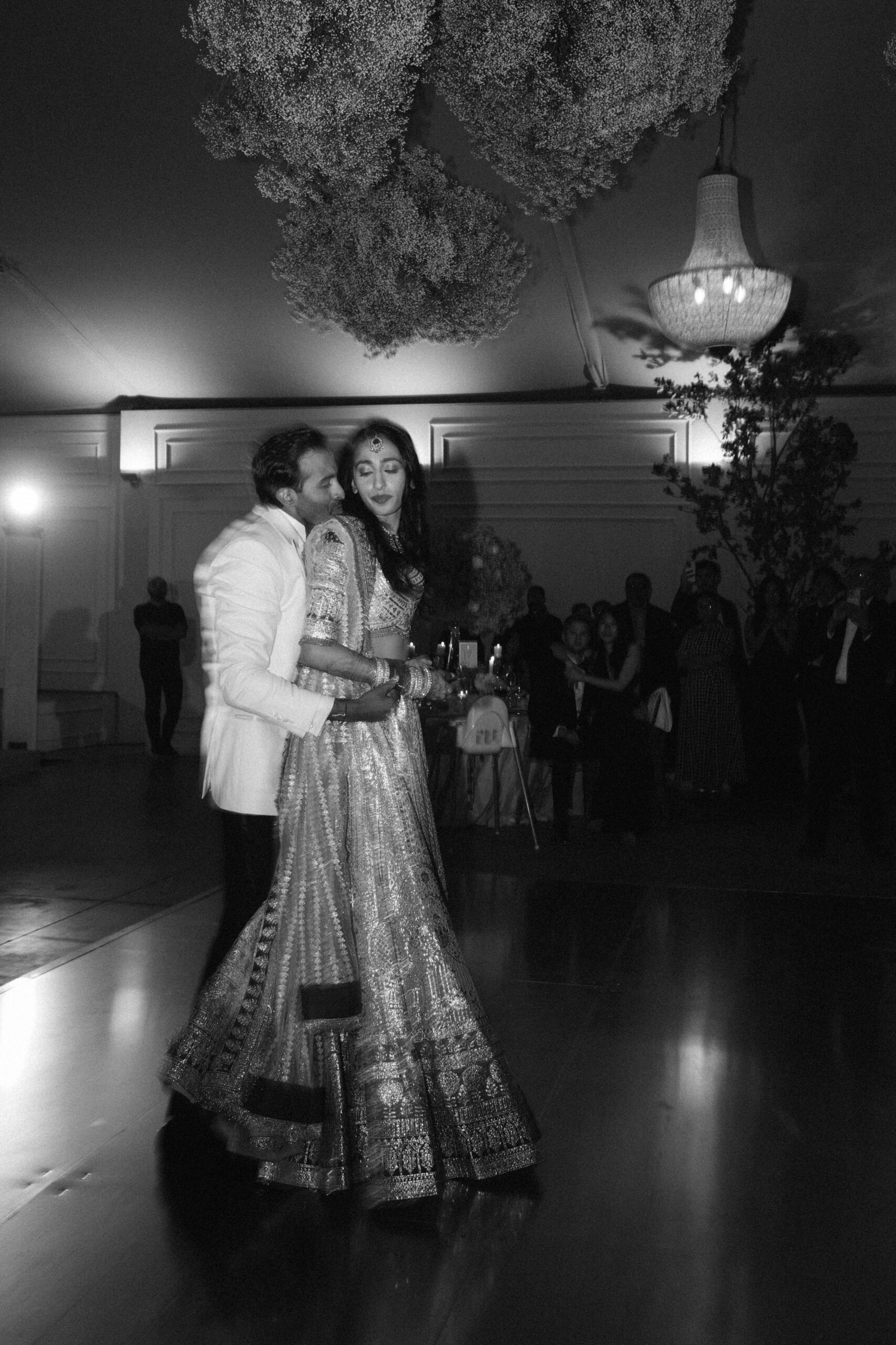 Couple's first dance by candlelight, the bride in a sequin lehenga, Lisbon wedding reception