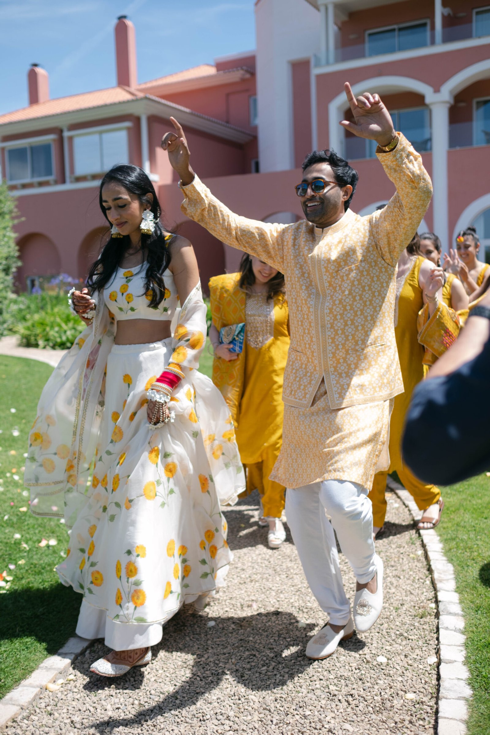 Couple dancing in yellow silk during the afternoon celebrations of their Lisbon wedding