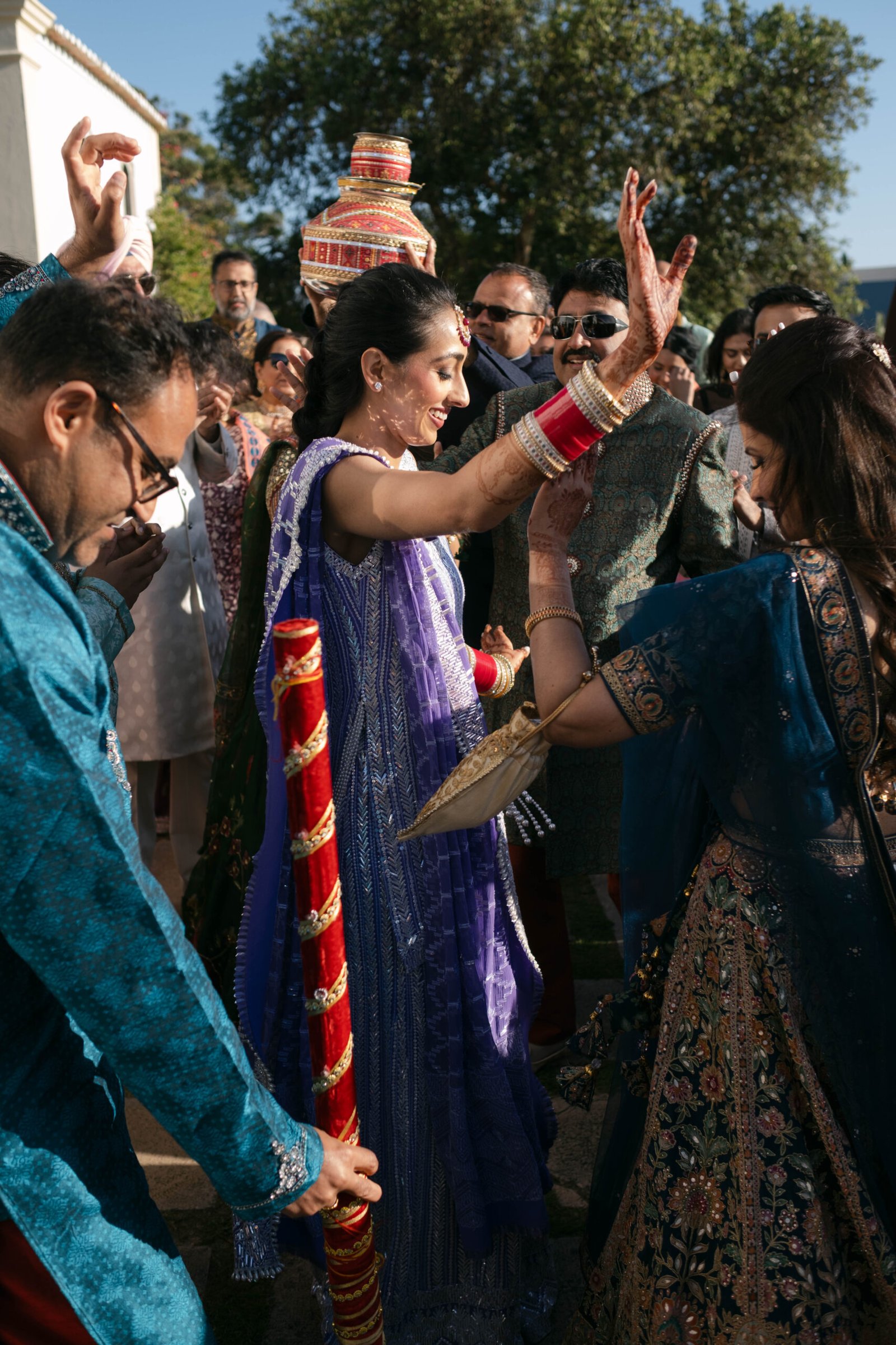 Bride and guests celebrating during the haldi ceremony in Lisbon, golden hour