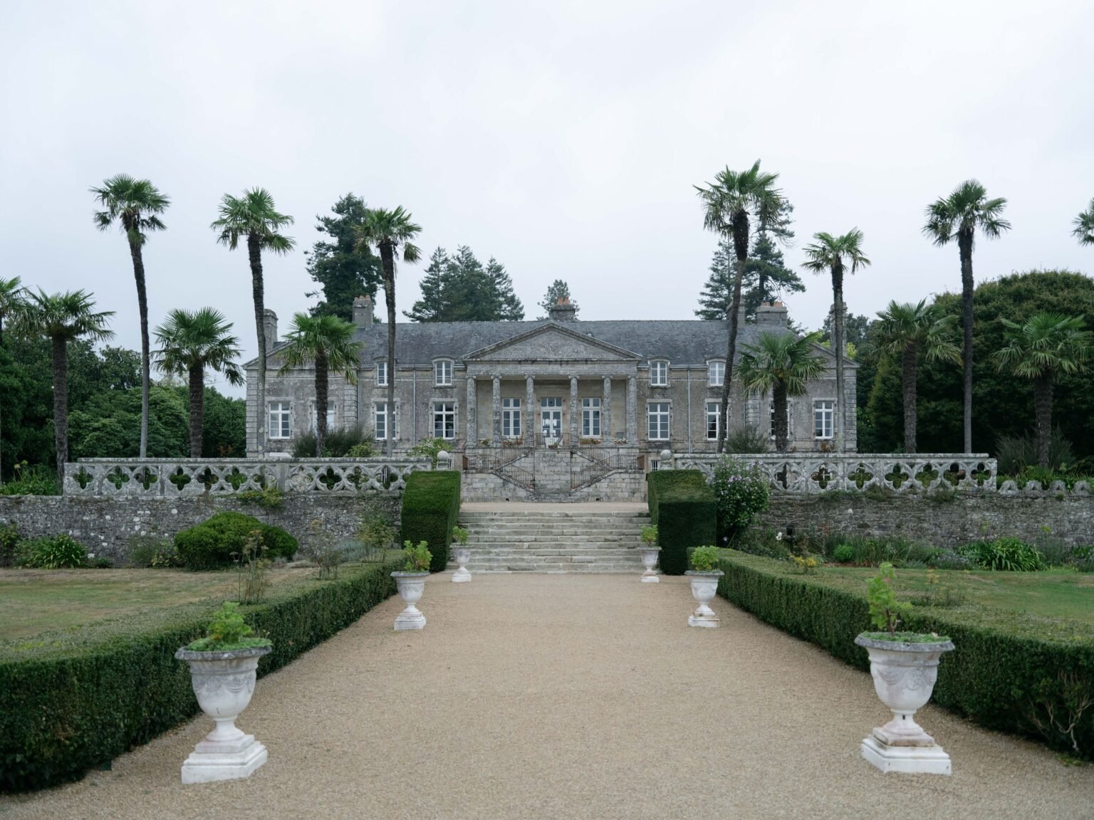 Orangerie de Lanniron wedding venue: the estate facade above formal French gardens under soft Brittany light