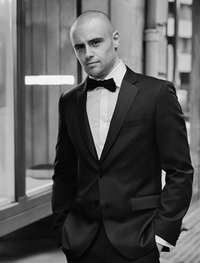 Justin, the cinematographer who films alongside Franklyn K, photographed in black tie